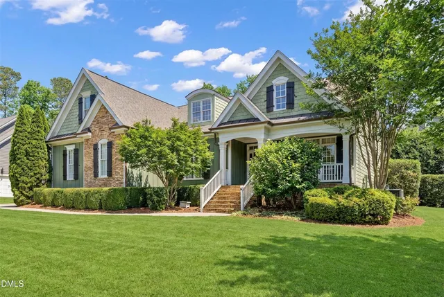 a front view of a house with a garden