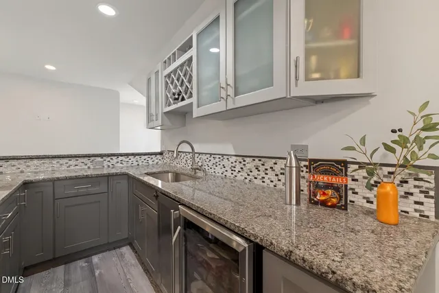 a view of a deck with couches table and chairs with wooden fence and plants