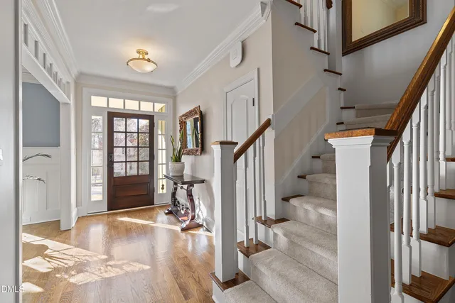 a view of a livingroom with wooden floor and stairs