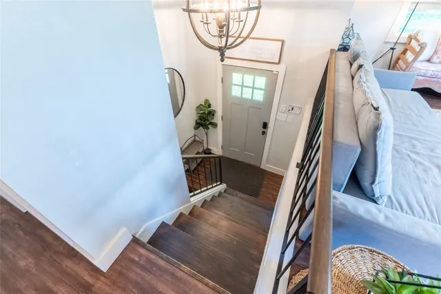 a view of staircase with white walls and a window