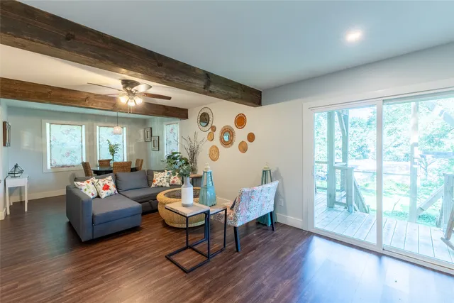 a living room with furniture and wooden floor