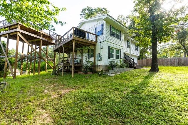 a view of house with deck and outdoor seating