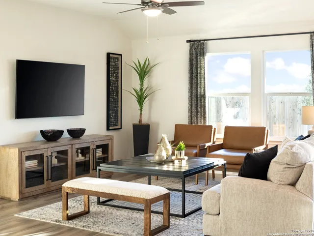 a living room with furniture and a flat screen tv