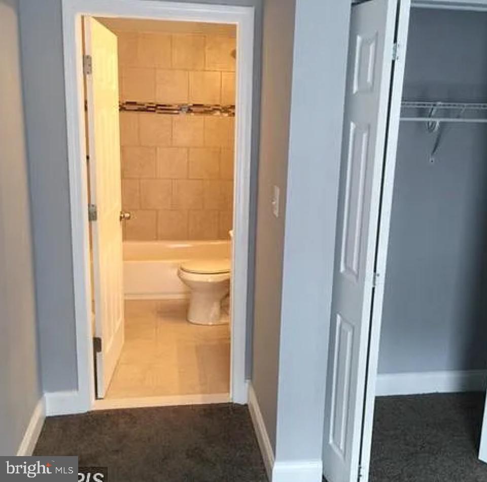 2023 West Lexington Street Baltimore, MD 21223 - Photo 6 of 10 a bathroom with a glass door shower and a toilet
