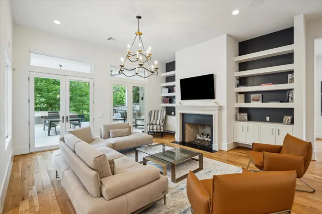 a living room with furniture a fireplace and a large window