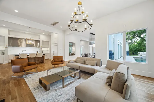 a living room with furniture or chandelier and a large window