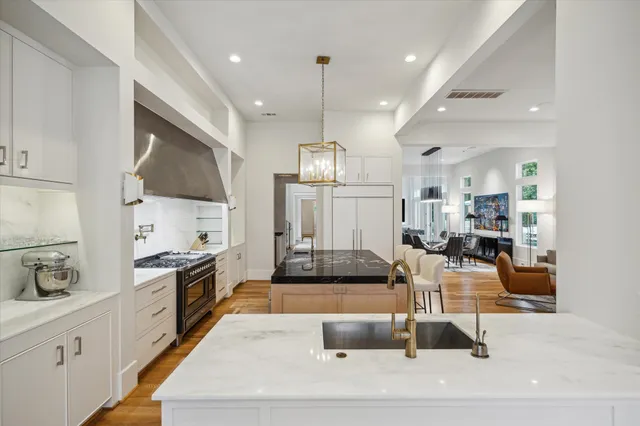 a kitchen with a dining table chairs and white cabinets