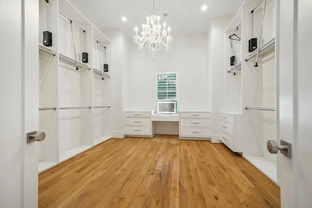 a large white bathroom with a granite countertop sink a mirror a bathtub and shower