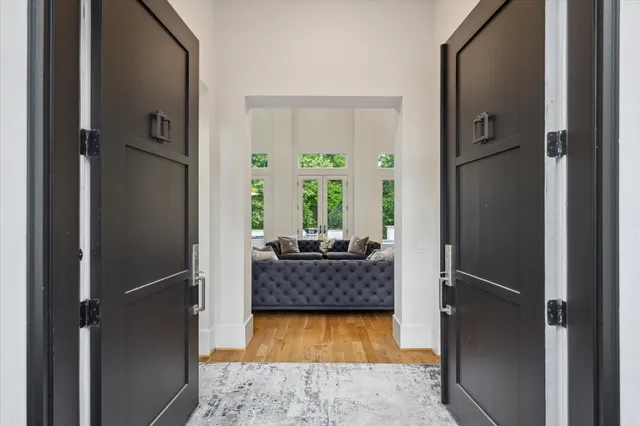 a living room with a bed and a dresser with wooden floor