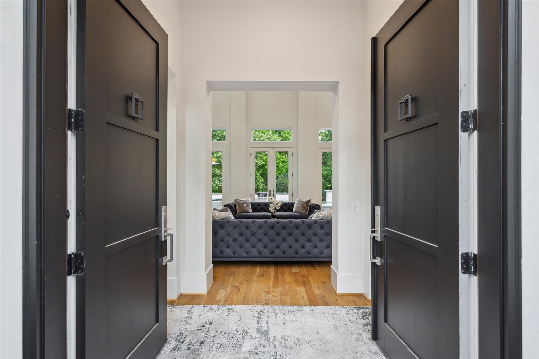 22 East Shady Lane, Unit E Houston, TX 77063 - Photo 6 of 50 Step into elegance at 22 East Shade Lane, Houston, through grand double doors, revealing a sophisticated living area.