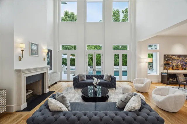 a living room with furniture fireplace and window