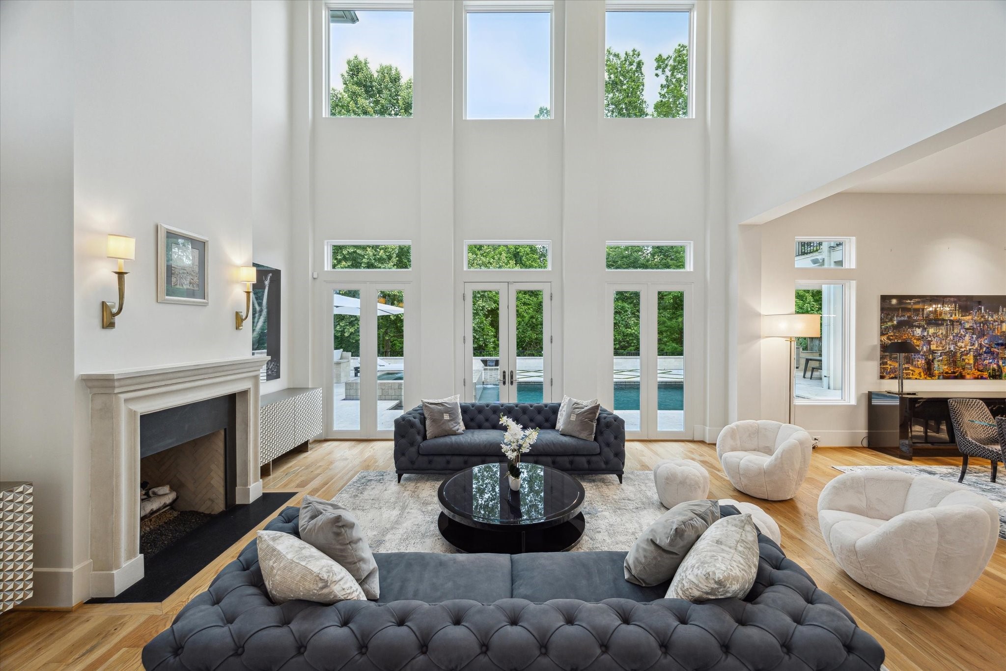 22 East Shady Lane, Unit E Houston, TX 77063 - Photo 7 of 50 The living room with soaring high ceilings and large windows flood the space with natural light, highlighting the elegant design.