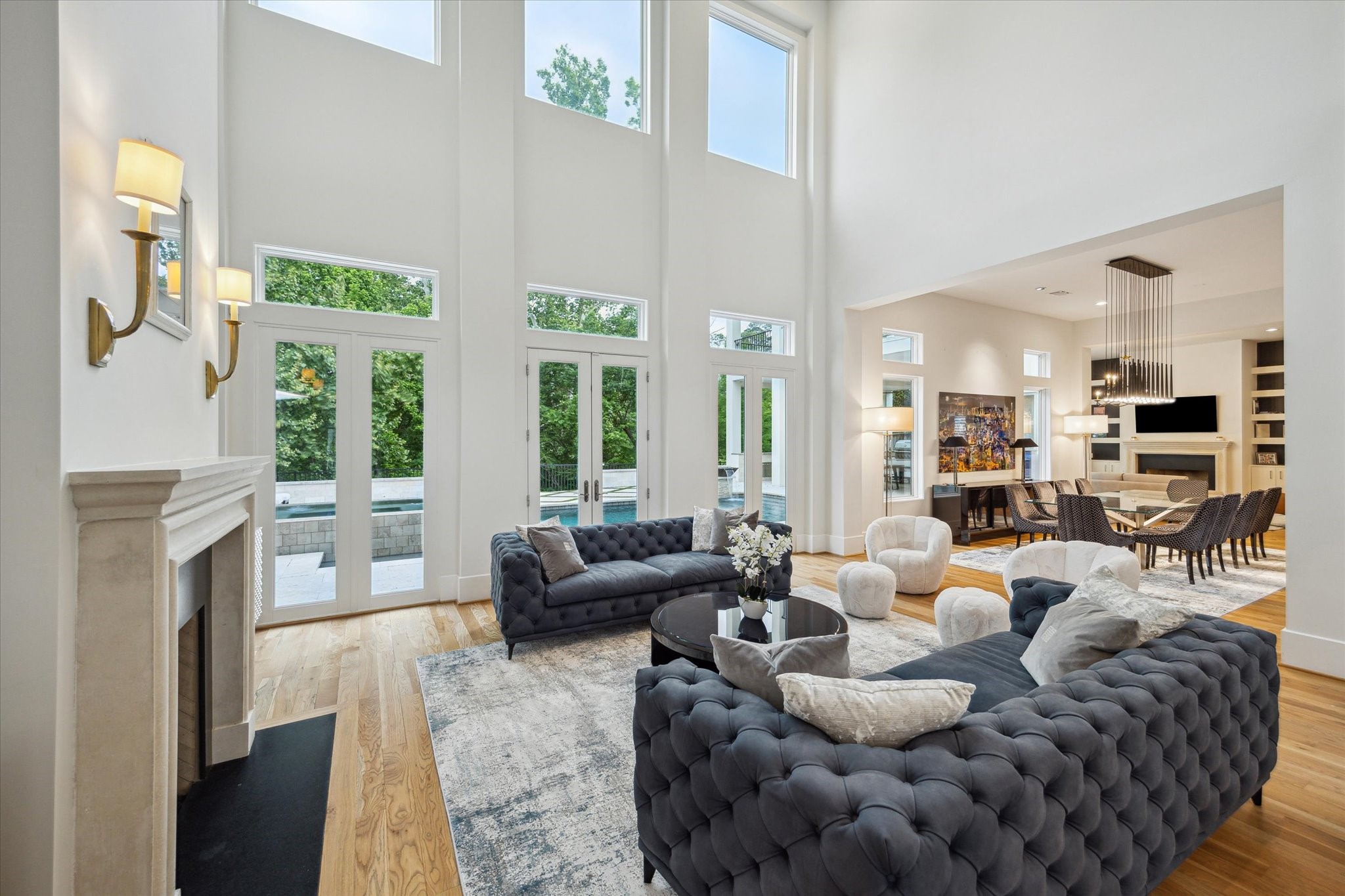 22 East Shady Lane, Unit E Houston, TX 77063 - Photo 8 of 50 The room features a fireplace with ambient , and an open layout extending to a dining area.