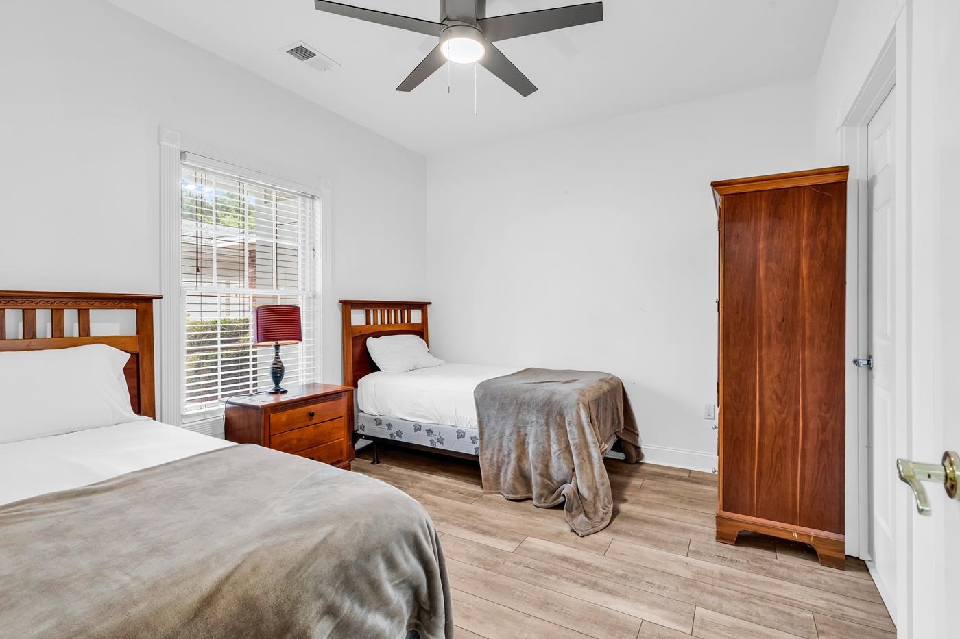 4801 Luster Leaf Circle, Unit 104 Myrtle Beach, SC 29577 - Photo 12 of 37 Bedroom with light wood-style flooring and ceiling fan