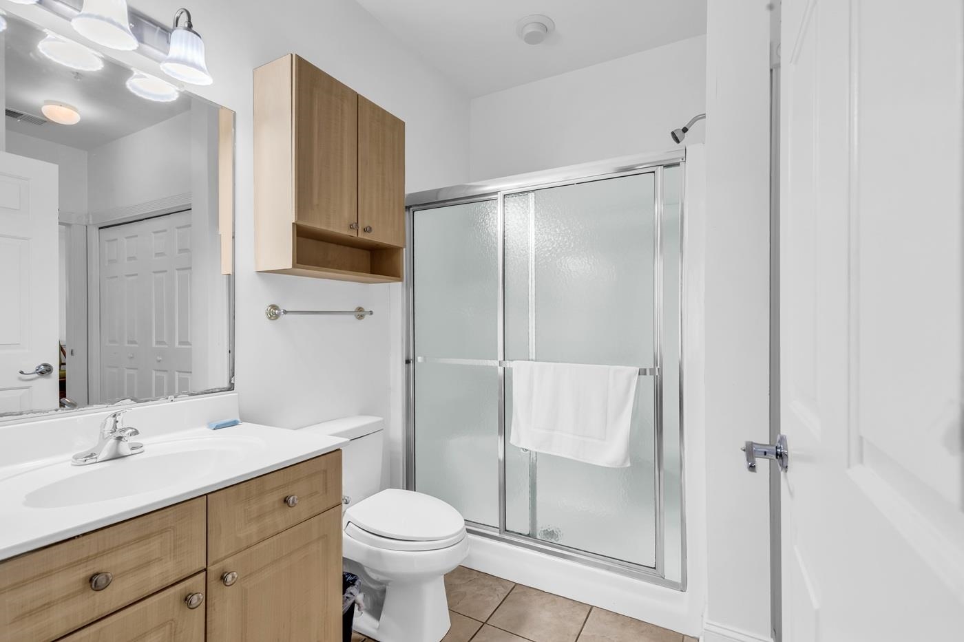 4801 Luster Leaf Circle, Unit 104 Myrtle Beach, SC 29577 - Photo 15 of 37 Bathroom featuring vanity, a shower stall, and light tile patterned floors
