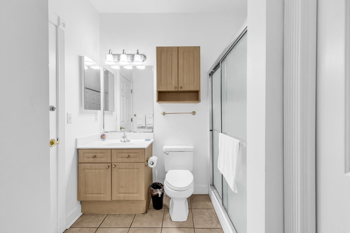 4801 Luster Leaf Circle, Unit 104 Myrtle Beach, SC 29577 - Photo 16 of 37 Full bathroom featuring a shower stall, vanity, and light tile patterned flooring