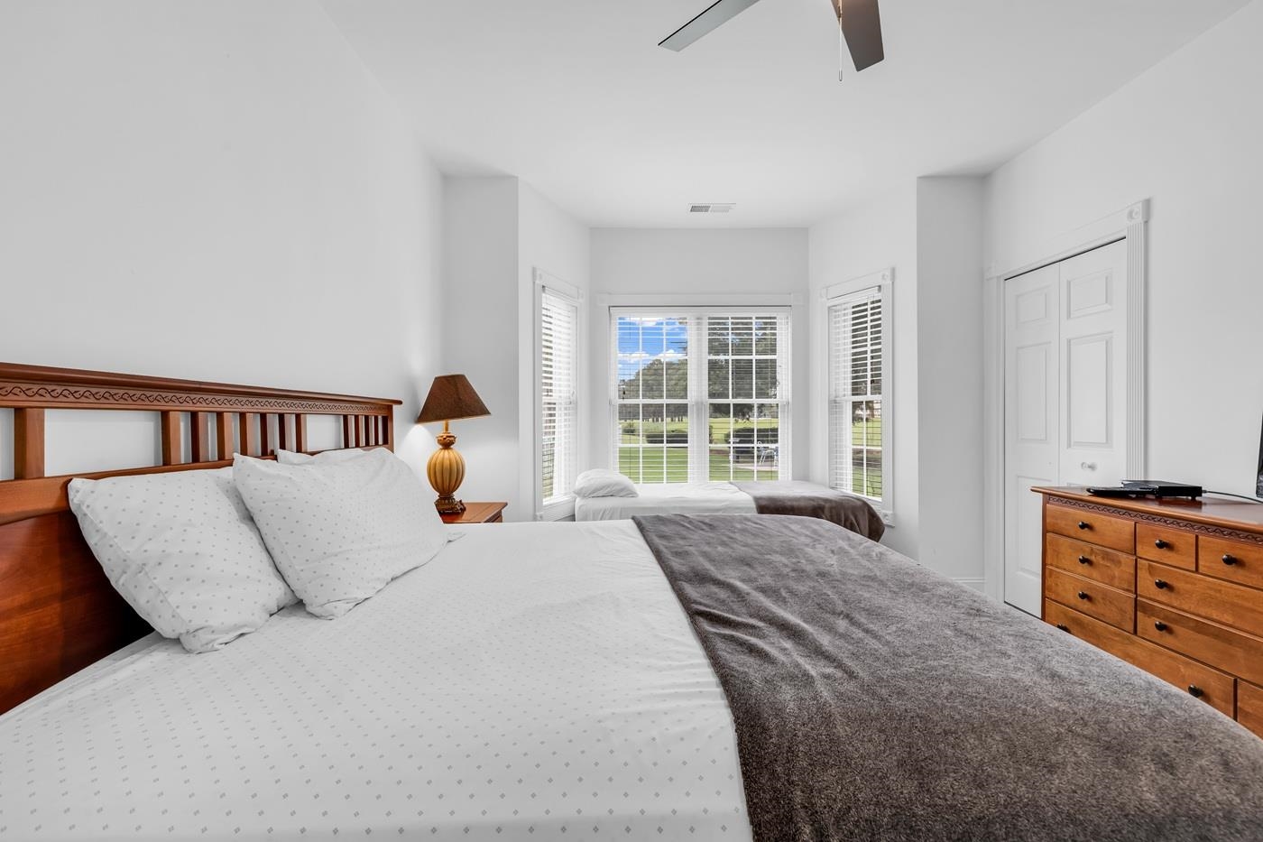 4801 Luster Leaf Circle, Unit 104 Myrtle Beach, SC 29577 - Photo 19 of 37 Bedroom with a closet and ceiling fan