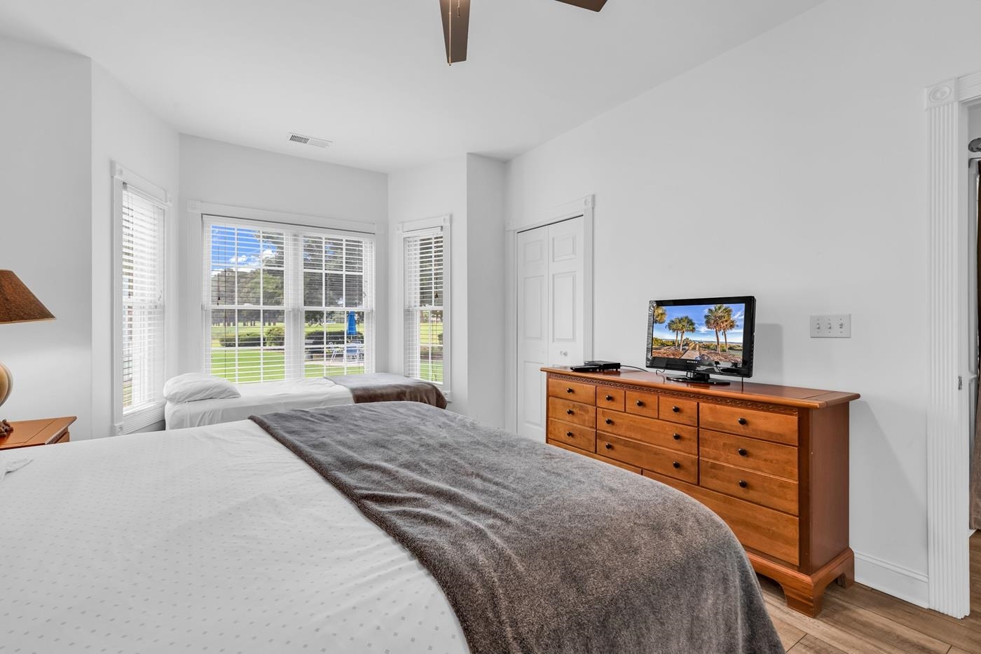4801 Luster Leaf Circle, Unit 104 Myrtle Beach, SC 29577 - Photo 20 of 37 Bedroom featuring a closet, a ceiling fan, and light wood finished floors