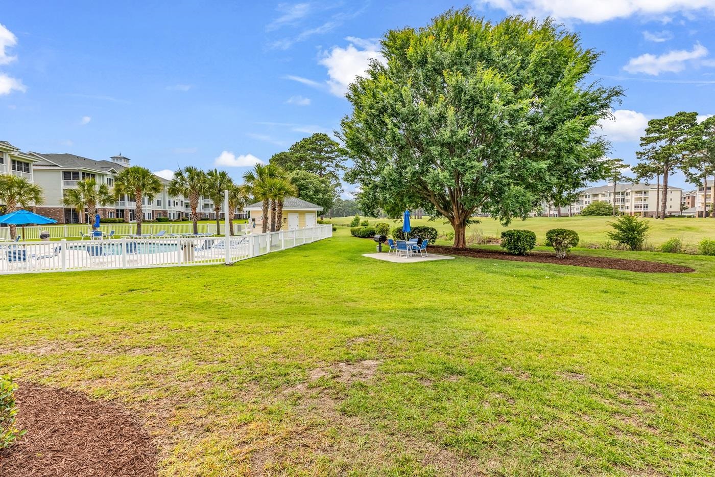 4801 Luster Leaf Circle, Unit 104 Myrtle Beach, SC 29577 - Photo 2 of 37 View of yard with a patio and a community pool