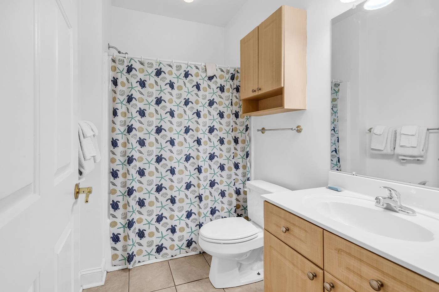 4801 Luster Leaf Circle, Unit 104 Myrtle Beach, SC 29577 - Photo 22 of 37 Bathroom featuring vanity, light tile patterned floors, and curtained shower