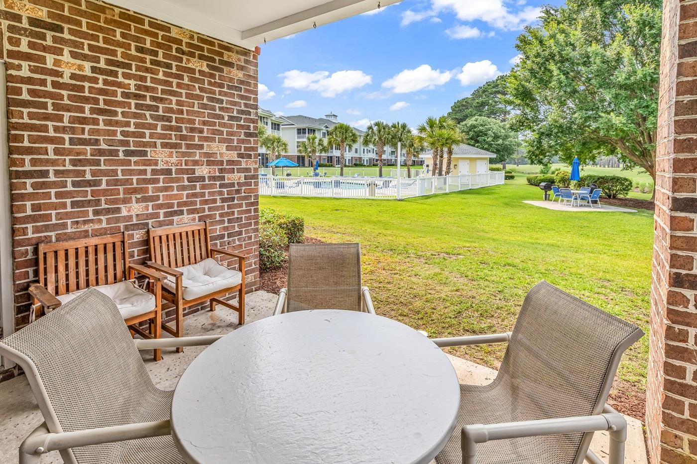 4801 Luster Leaf Circle, Unit 104 Myrtle Beach, SC 29577 - Photo 24 of 37 View of patio with outdoor dining area and a pool