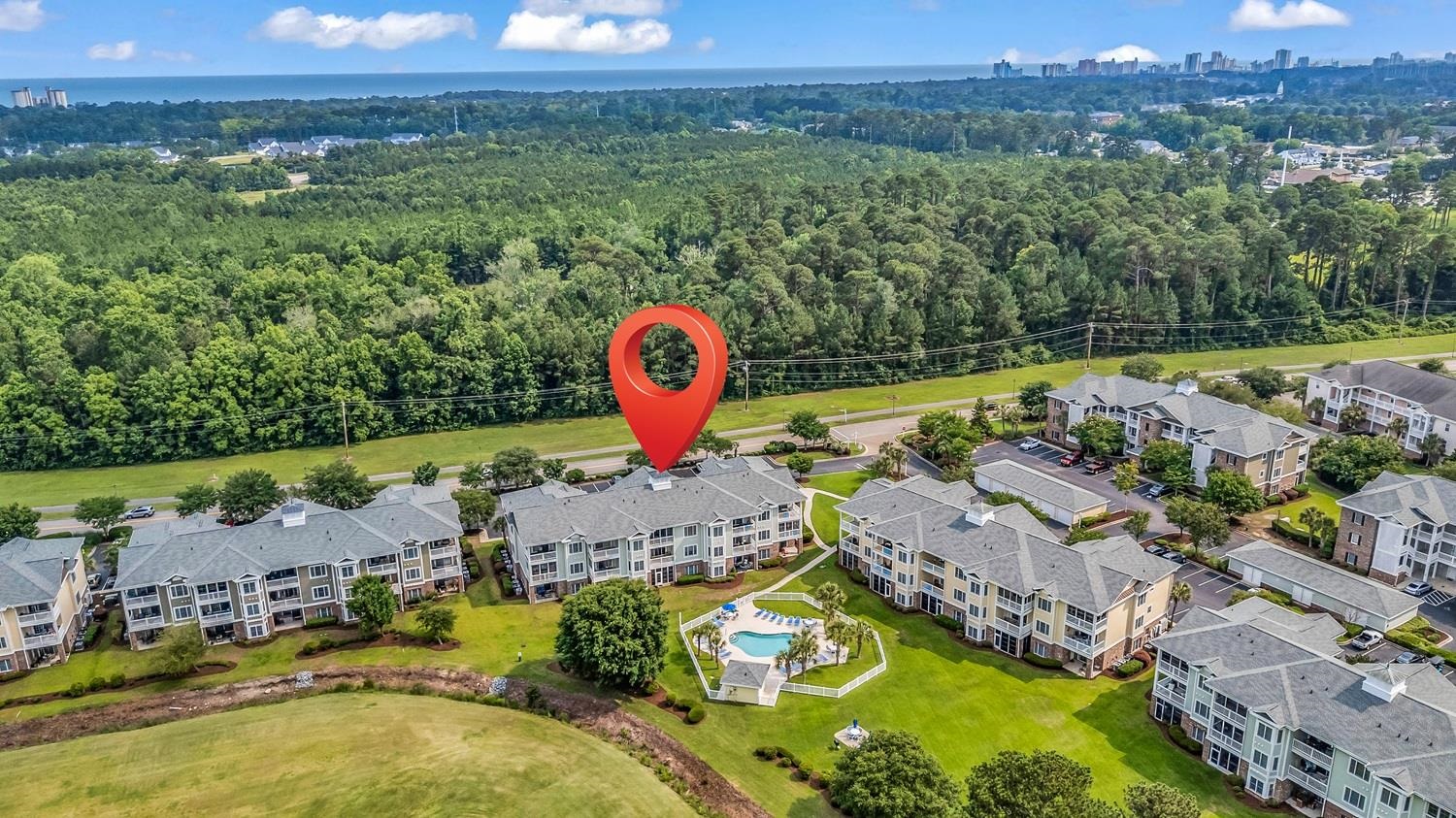 4801 Luster Leaf Circle, Unit 104 Myrtle Beach, SC 29577 - Photo 35 of 37 Bird's eye view of a forest and city skyline