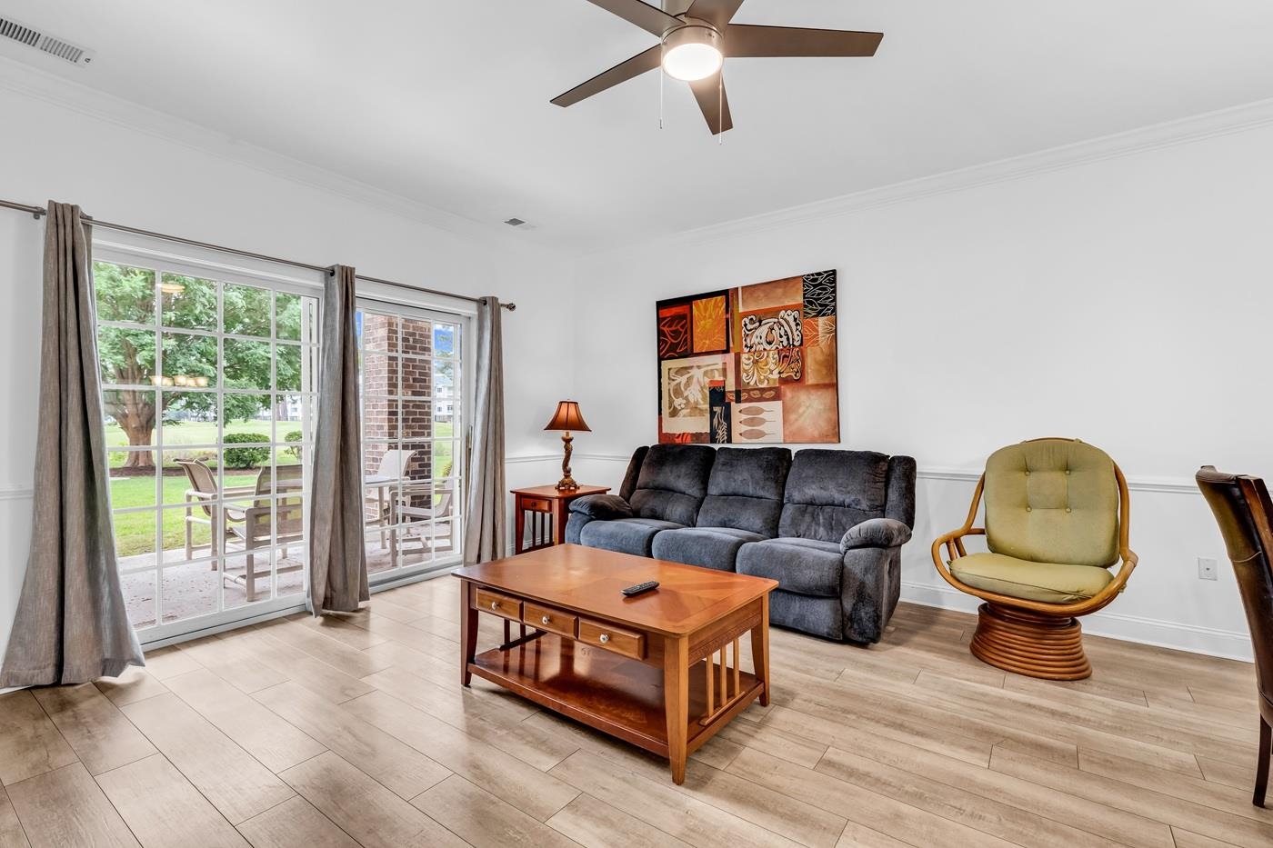 4801 Luster Leaf Circle, Unit 104 Myrtle Beach, SC 29577 - Photo 8 of 37 Living area with ornamental molding, light wood-style floors, and a ceiling fan