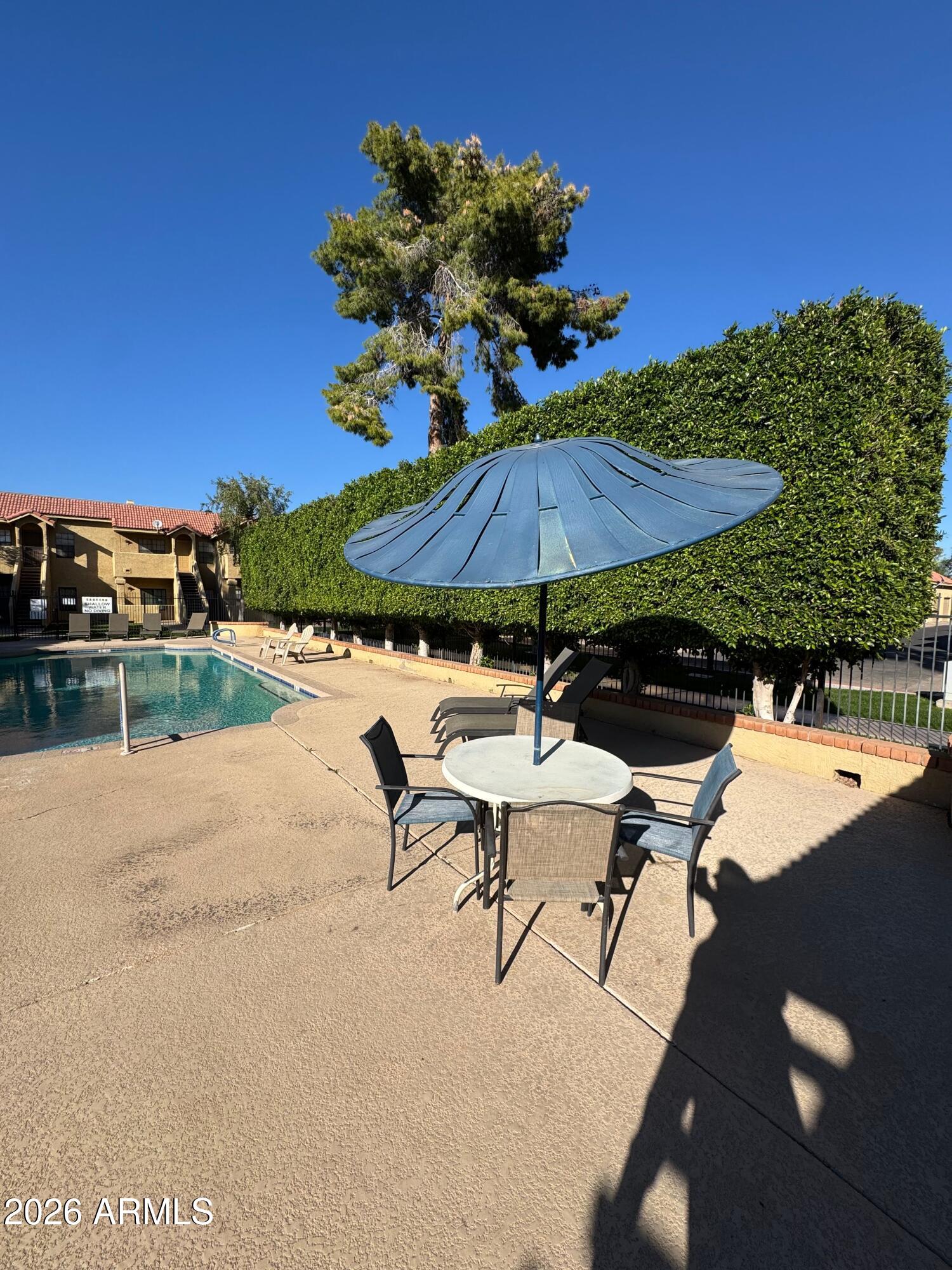 1126 West Elliot Road, Unit 1061 Chandler, AZ 85224 - Photo 12 of 24 a view of a backyard with sitting area