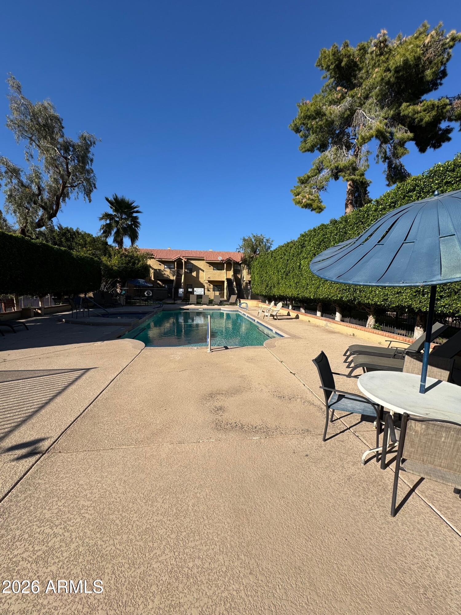 1126 West Elliot Road, Unit 1061 Chandler, AZ 85224 - Photo 13 of 24 a view of swimming pool with outdoor seating