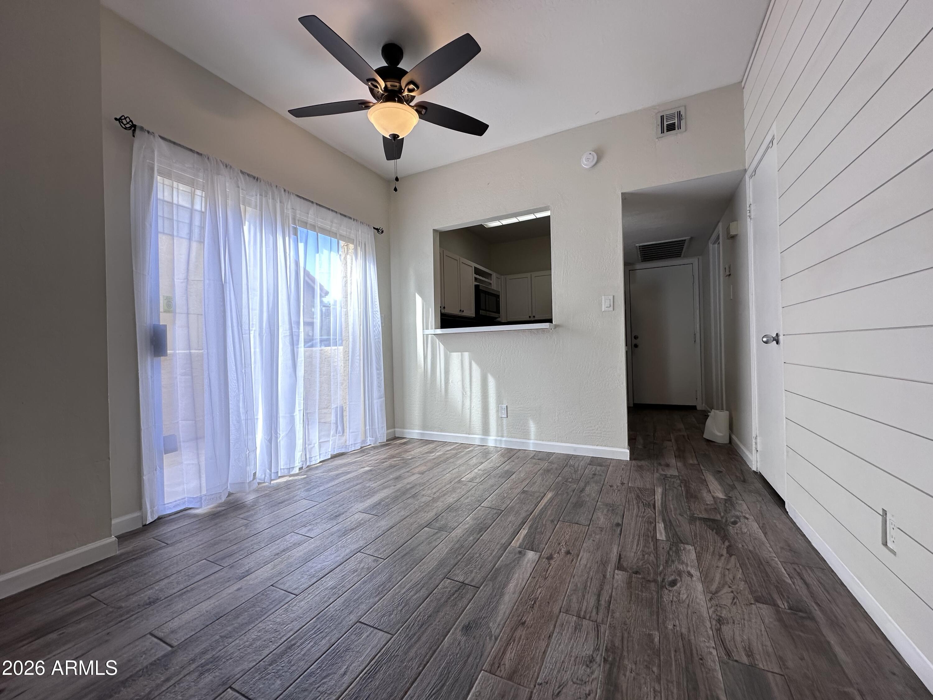 1126 West Elliot Road, Unit 1061 Chandler, AZ 85224 - Photo 3 of 24 a view of a livingroom with a flat screen tv