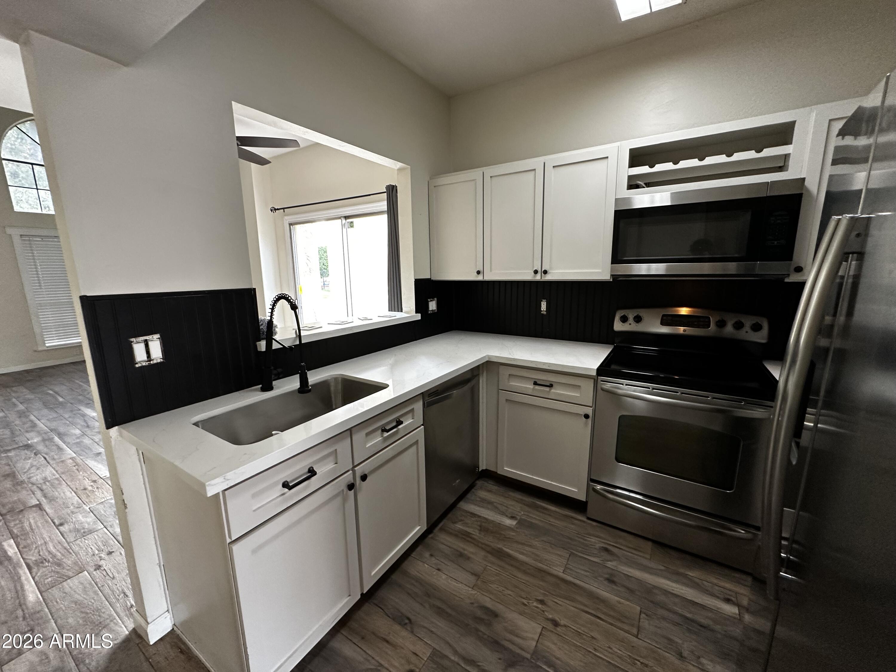 1126 West Elliot Road, Unit 1061 Chandler, AZ 85224 - Photo 5 of 24 a kitchen with a sink stove and microwave