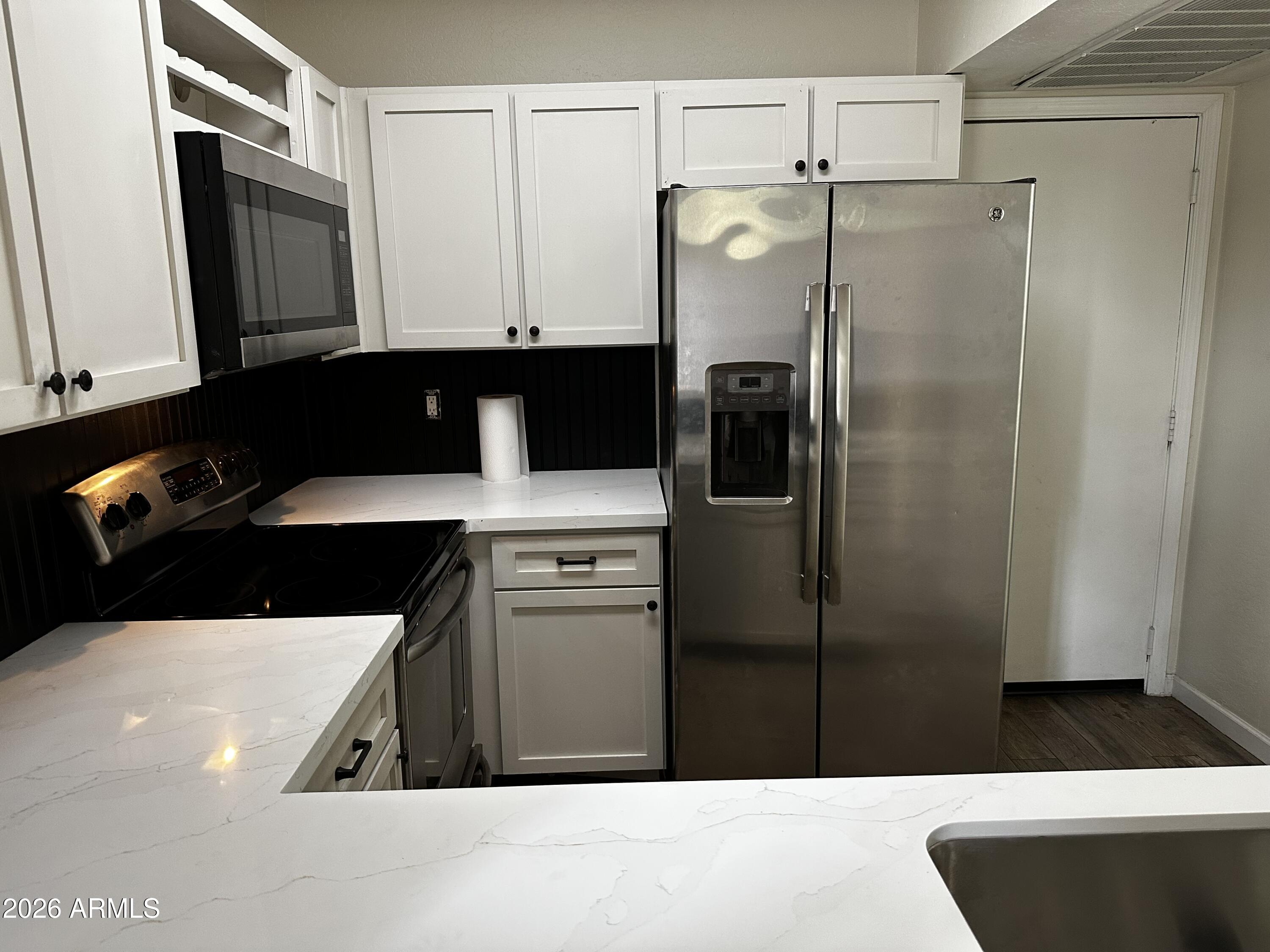 1126 West Elliot Road, Unit 1061 Chandler, AZ 85224 - Photo 6 of 24 a kitchen with a refrigerator sink and cabinets
