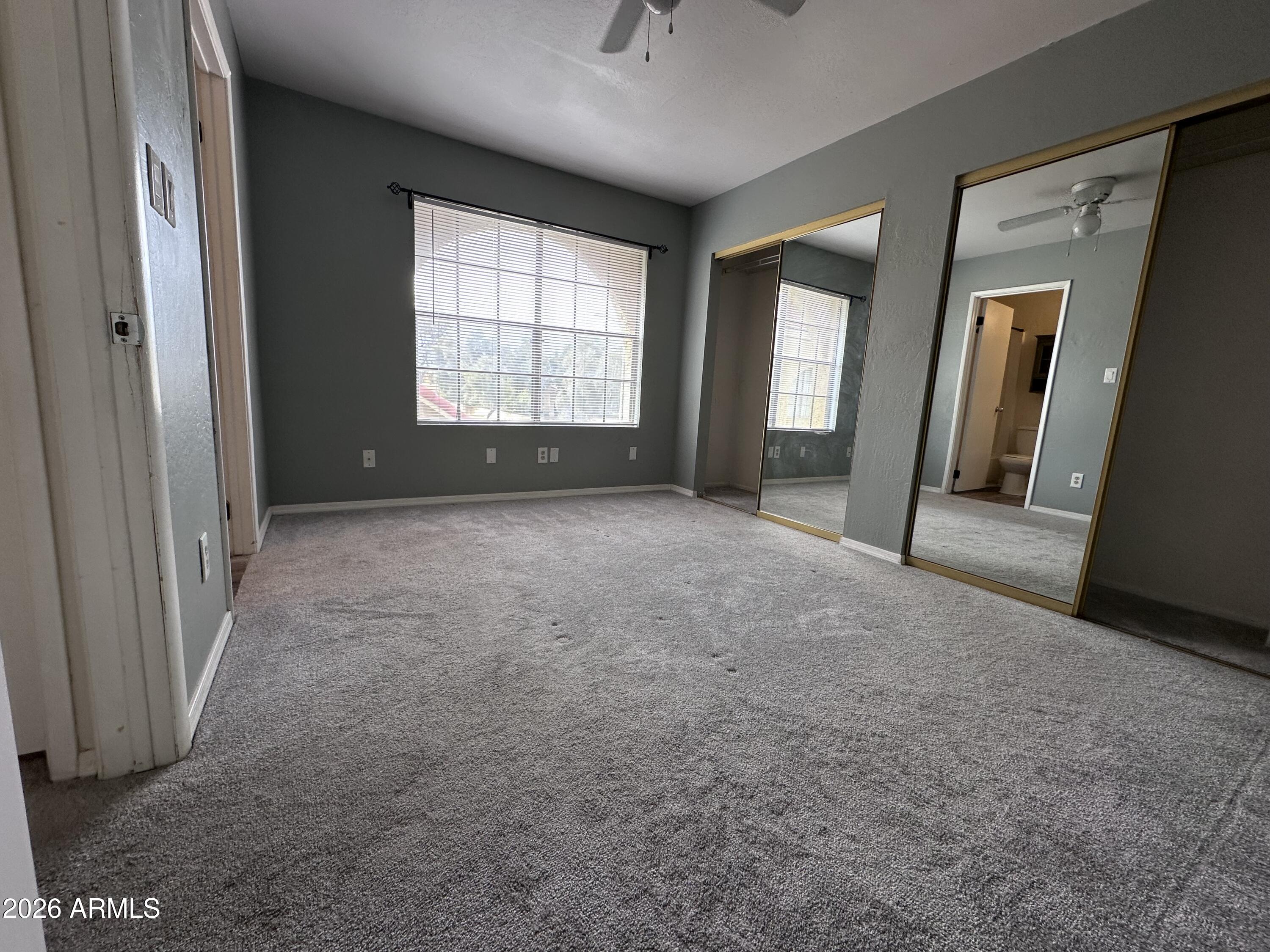 1126 West Elliot Road, Unit 1061 Chandler, AZ 85224 - Photo 8 of 24 an empty room with windows and closet