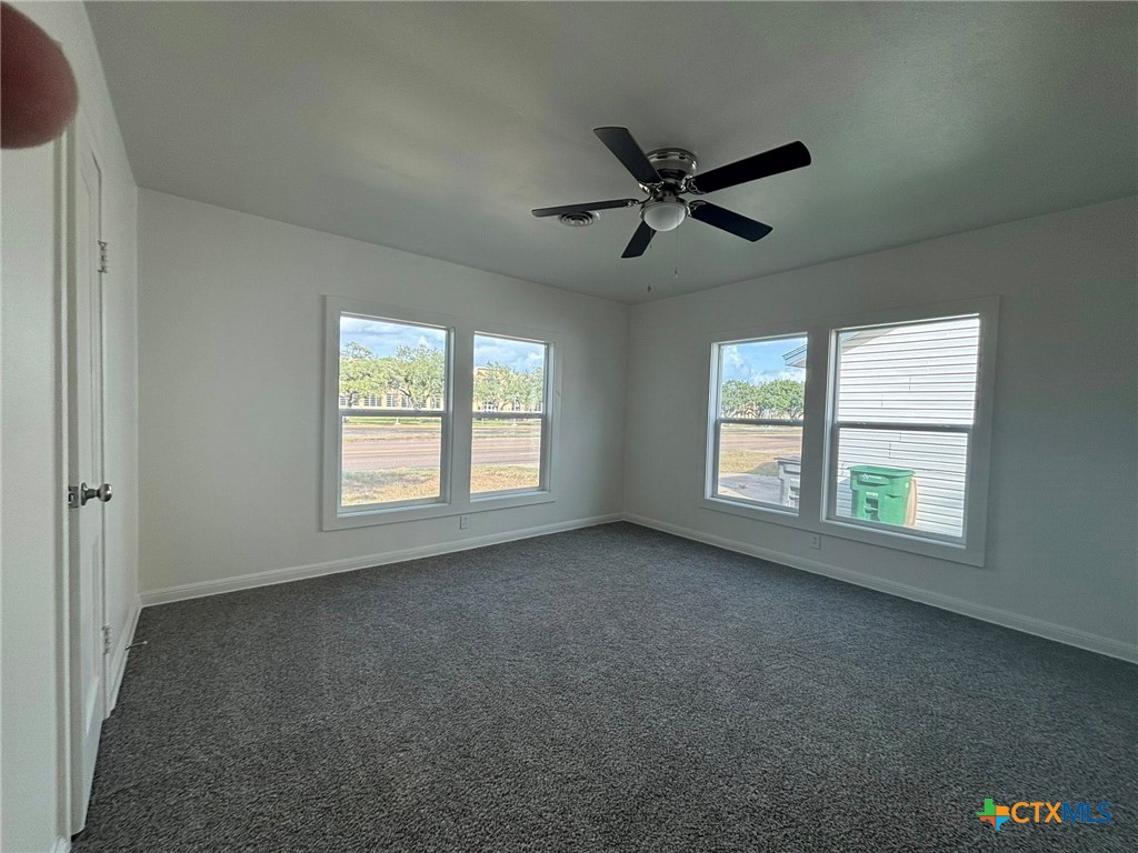 2111 East Red River Street Victoria, TX 77901 - Photo 4 of 7 a view of empty room with windows