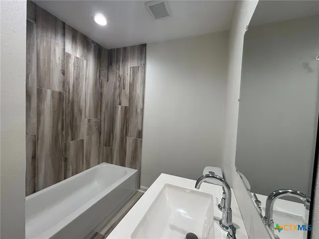 a bathroom with a sink and a tub