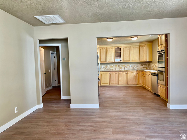 255 West Main Street Mount Pleasant, UT 84647 - Photo 7 of 35 Kitchen featuring light wood cabinetry, a mosaic tile backsplash, stainless steel appliances, and ceiling-mounted lighting