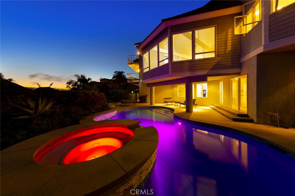 a view of swimming pool with red chairs