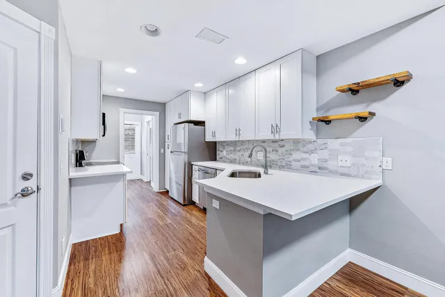 a kitchen with a sink a counter space and appliances