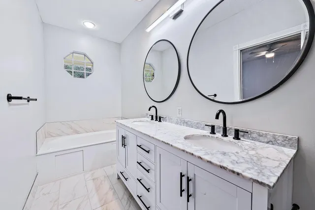 a bathroom with a granite countertop sink a mirror and a