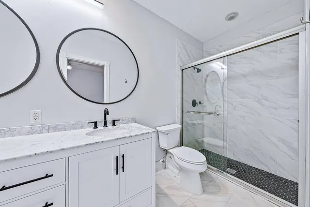 a bathroom with a toilet a sink and a mirror