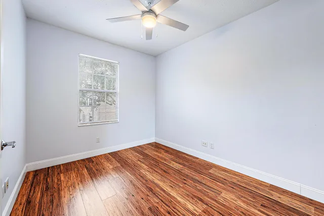 wooden floor in an empty room with a window