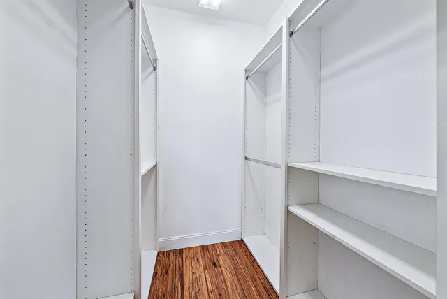 a view of walk in closet with empty racks