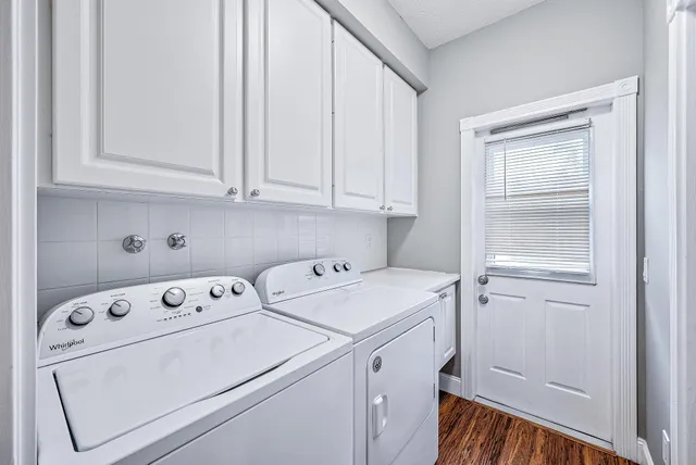 a view of washer and dryer with kitchen in the background