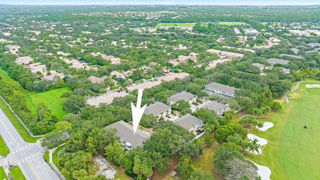 an aerial view of residential houses with outdoor space and trees