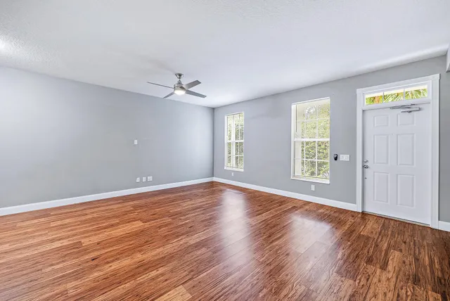 wooden floor in an empty room with a window