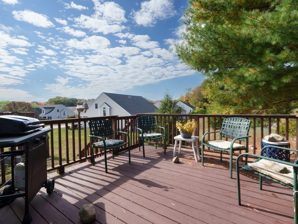15 Fox Run Road, Unit 15 Blackstone, MA 01504 - Photo 22 of 22 a view of a deck with two chairs and wooden floor