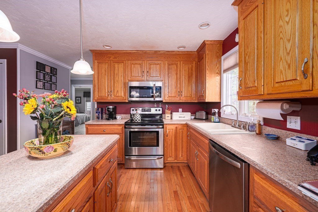 15 Fox Run Road, Unit 15 Blackstone, MA 01504 - Photo 3 of 22 a kitchen with stainless steel appliances granite countertop a stove top oven a sink dishwasher and cabinets with wooden floor