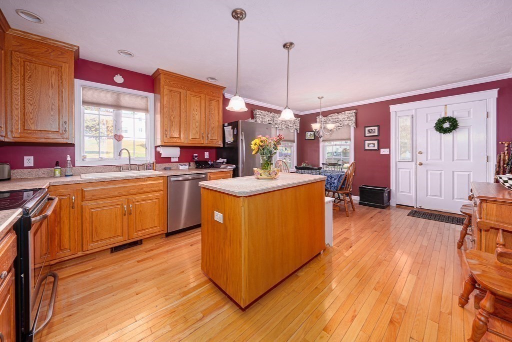 15 Fox Run Road, Unit 15 Blackstone, MA 01504 - Photo 6 of 22 a kitchen with stainless steel appliances granite countertop wooden floors sink and cabinets