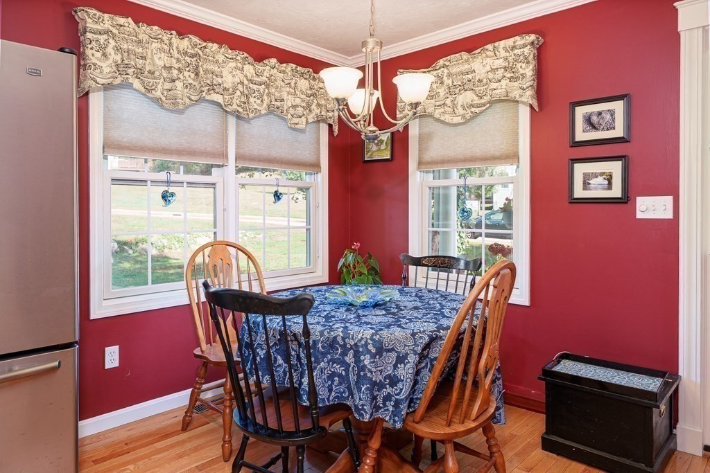 15 Fox Run Road, Unit 15 Blackstone, MA 01504 - Photo 8 of 22 a view of a dining room with furniture a chandelier and wooden floor