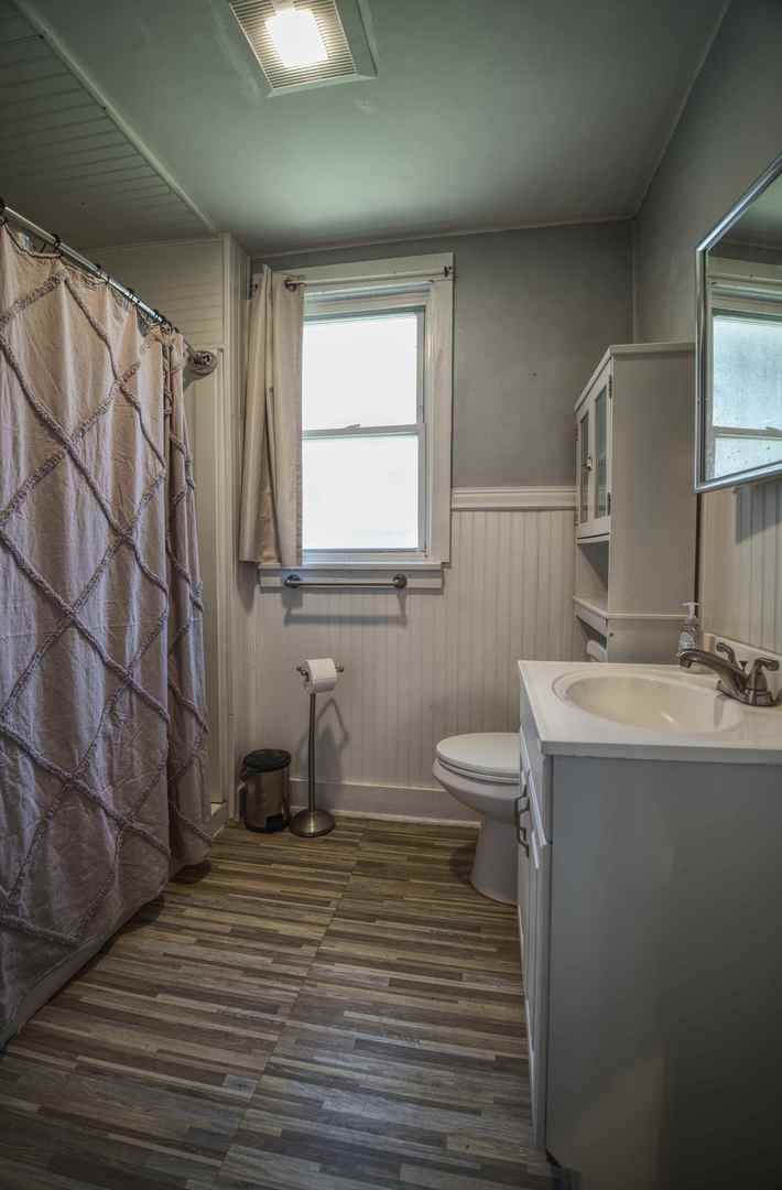 2108 Camanche Avenue Clinton, IA 52732 - Photo 8 of 22 a bathroom with a sink a toilet and mirror
